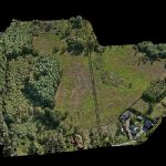 Aerial view of a large 247-acre landscape mapped with LiDAR drone scanning technology for resort planning, showing detailed elevation changes, tree density, and lake proximity for optimal cabin placement.