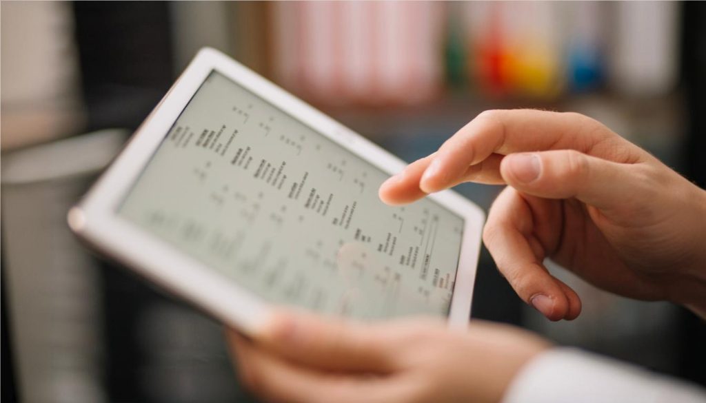 Hand holding a tablet with data, highlighting as-built services for historical preservation