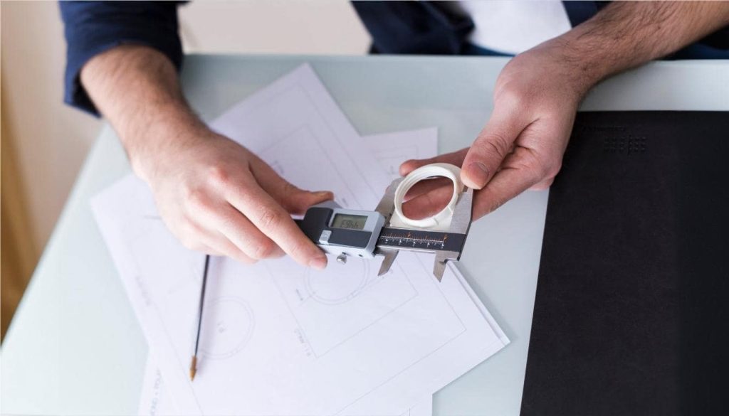 Measuring components for As-Built CAD drawings in custom furniture manufacturing.