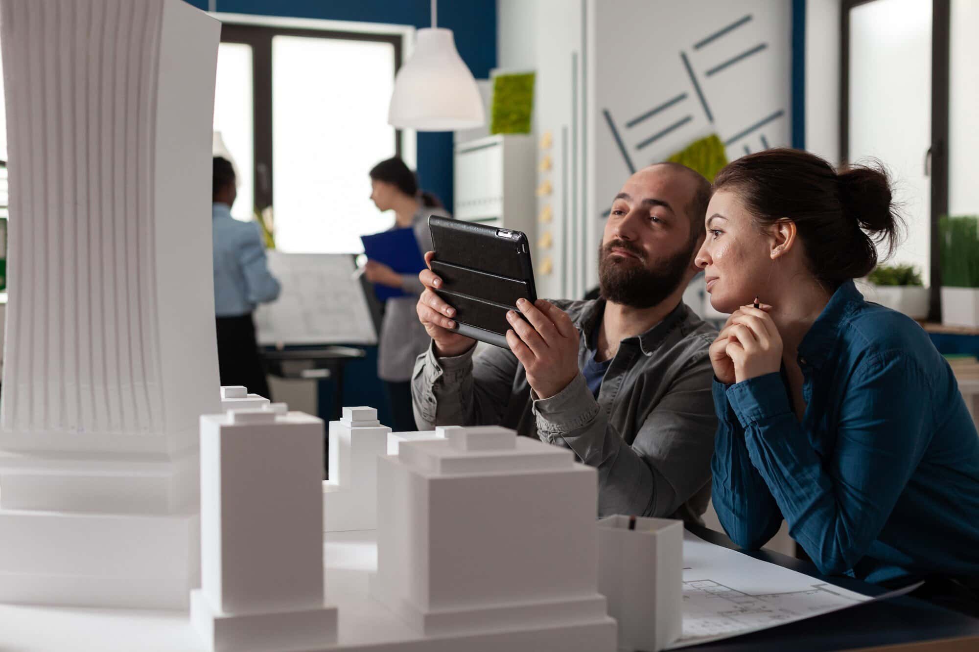 Real estate agent using a 3D model on a laptop to create a virtual property tour.