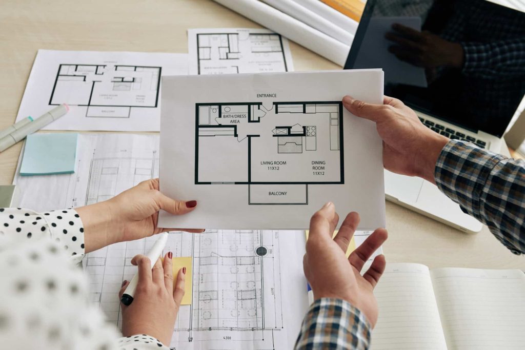 Reviewing apartment renovation plans with As-Built drawings for small apartment redesign.