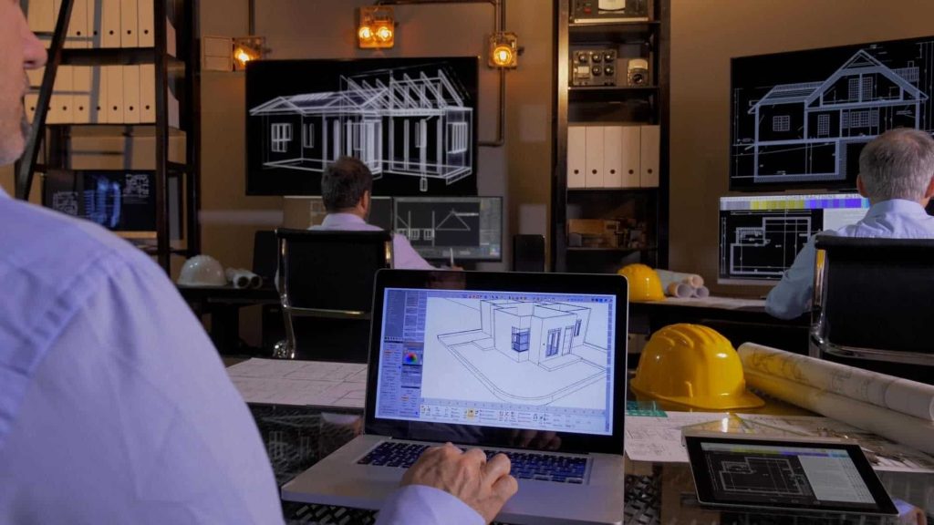 Engineers using 3D modeling software for structural analysis and building design in a modern workspace.